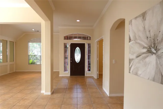 a view of a hallway with entryway and front door