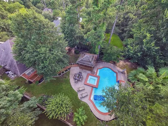 an aerial view of residential house with outdoor space and swimming pool