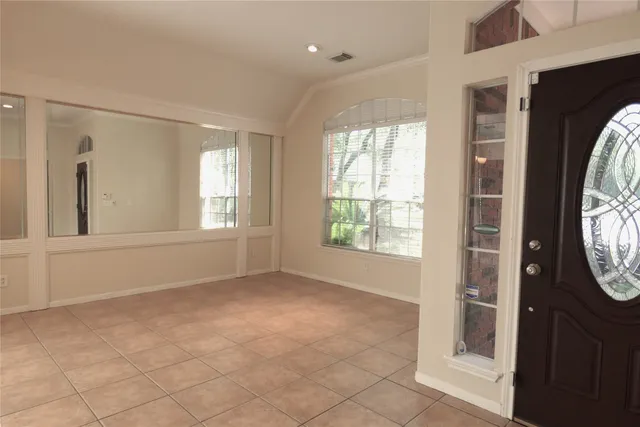 a view of a hallway with a large window and a mirror