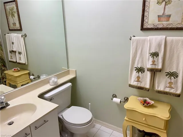 a bathroom with a sink toilet and a mirror