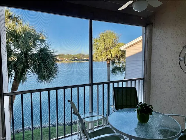 a view of a balcony with chair and potted plants