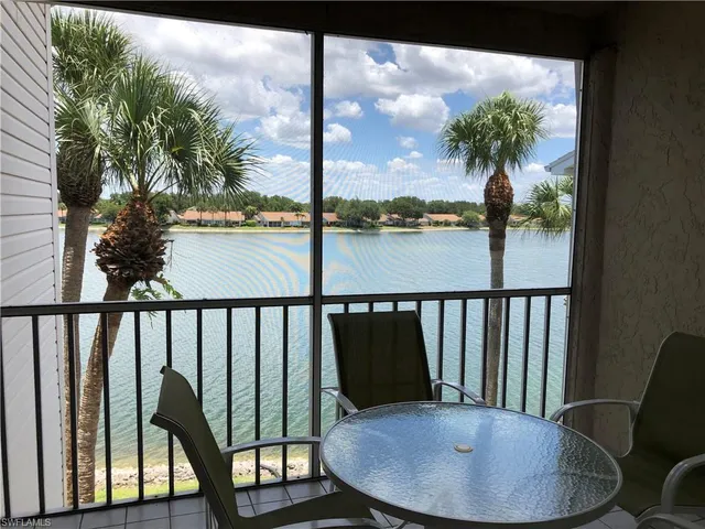 a view of a chairs and table in the balcony