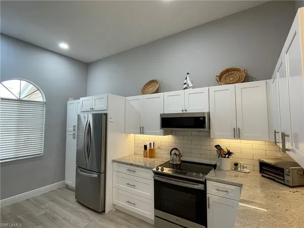 a kitchen with stainless steel appliances a refrigerator a stove a sink and a stove