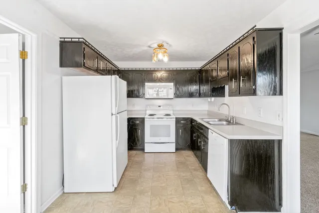 a kitchen with stainless steel appliances a stove a sink and a refrigerator