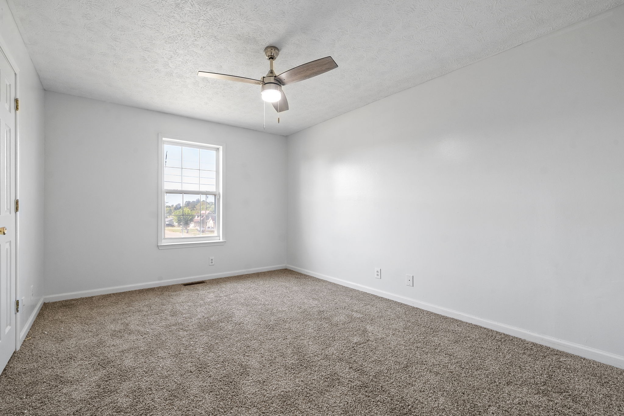 100 Karen Court Oak Grove, KY 42262 - Photo 8 of 11 an empty room with a window and ceiling fan