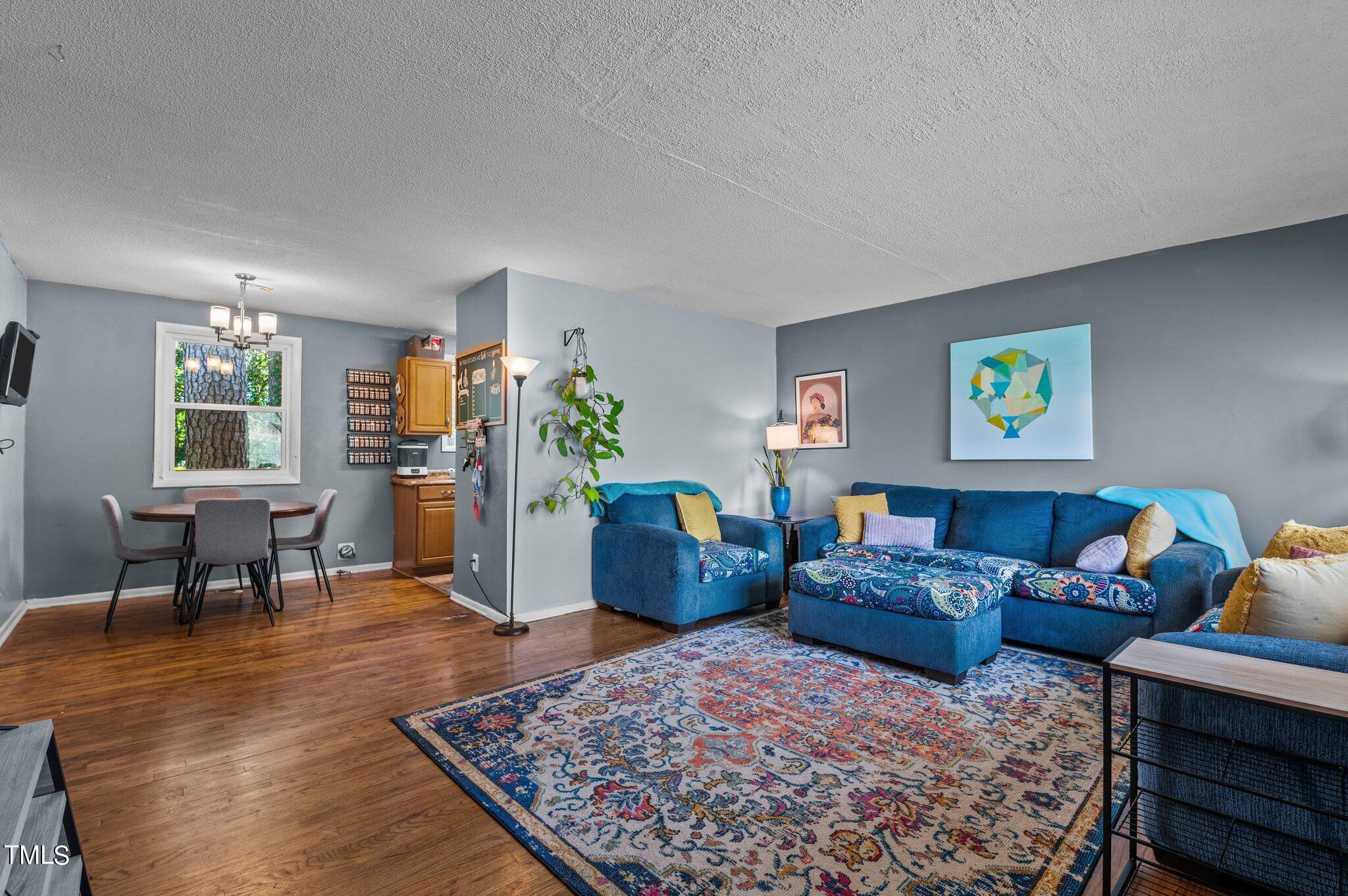 1708 Tee Dee Street Raleigh, NC 27610 - Photo 15 of 16 a living room with furniture and a wooden floor