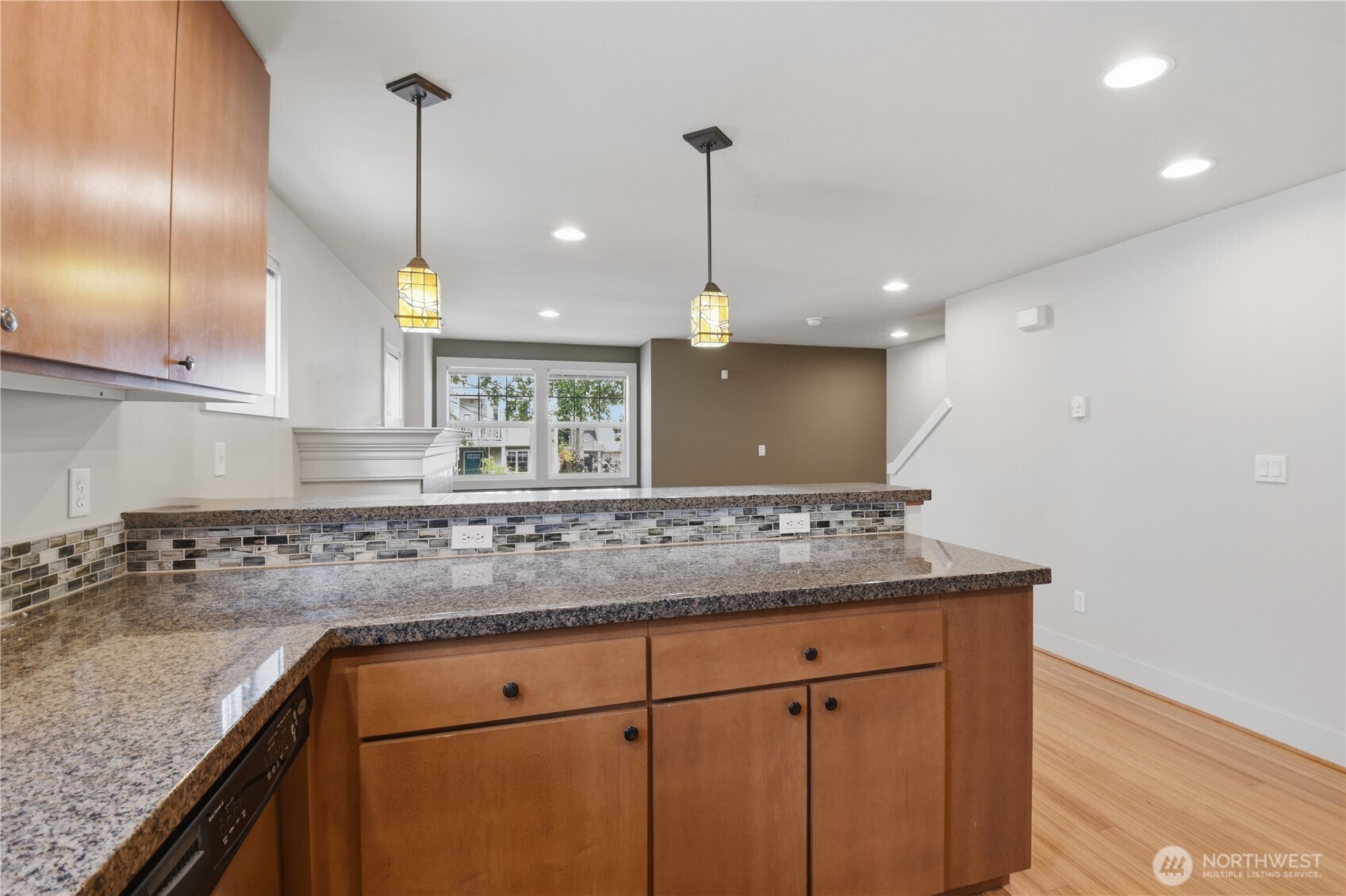 723 North 95th Street, Unit A Seattle, WA 98103 - Photo 4 of 20 a kitchen with kitchen island a counter space a sink and cabinets