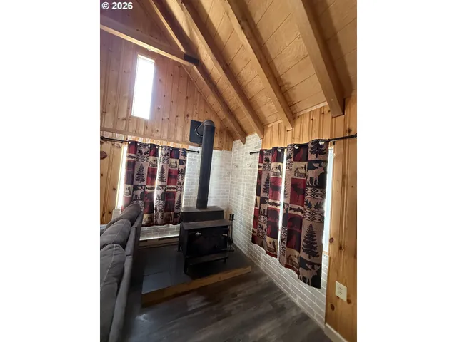 a view of living room with furniture and wooden floor