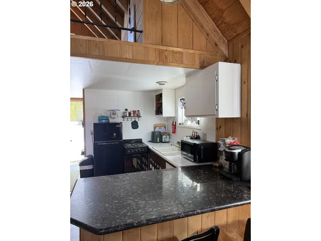 a kitchen with a sink and a stove top oven