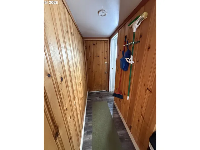 a view of wooden house with a yard