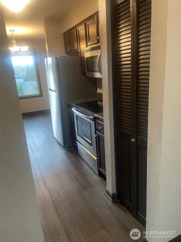 a kitchen with metallic refrigerator and sink