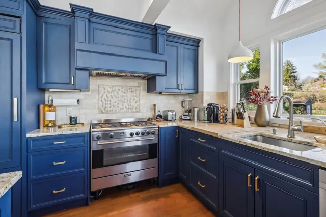 a kitchen with granite countertop wooden cabinets and white appliances