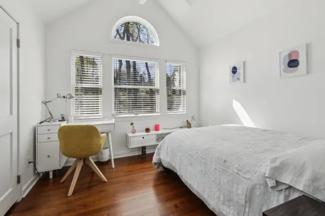 a bedroom with a bed and a chair