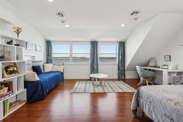 a bedroom with furniture and a book shelf