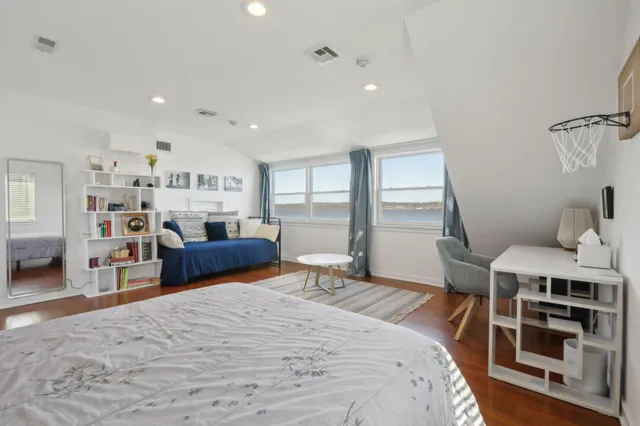 a bedroom with furniture and a wooden floor