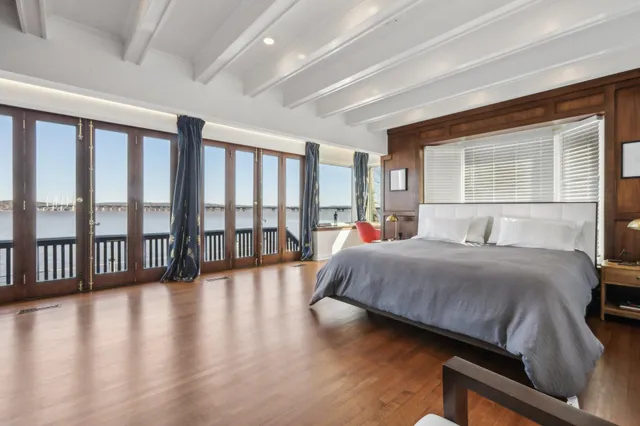 a bedroom with a large bed and a large window