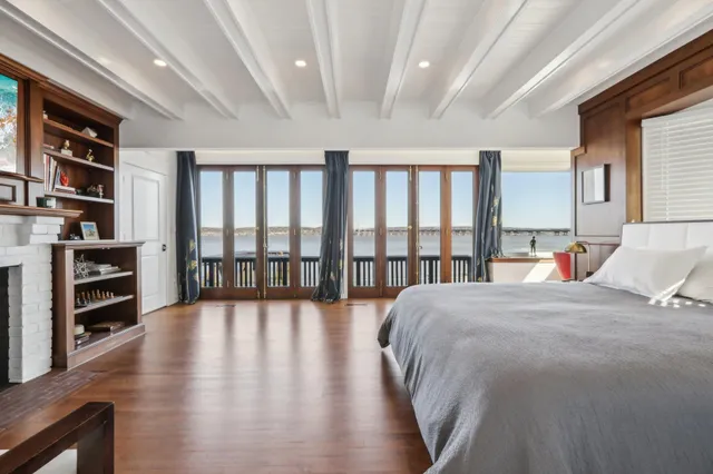 a living room with furniture hardwood floor and bookshelf