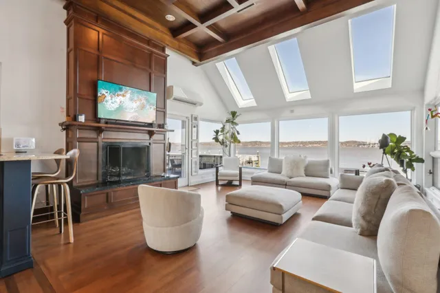a living room with furniture a fireplace and a flat screen tv