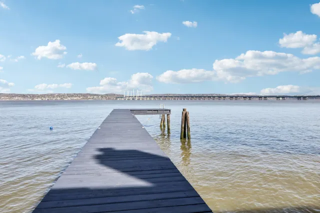 a small pool with lawn chairs and flat screen tv