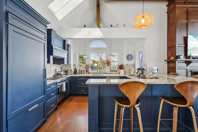a kitchen with stainless steel appliances granite countertop wooden cabinets and a stove