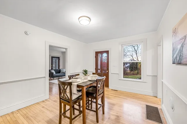 a view of a dining room with furniture and wooden floor