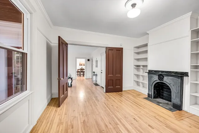 a view of a livingroom with a fireplace and wooden floor