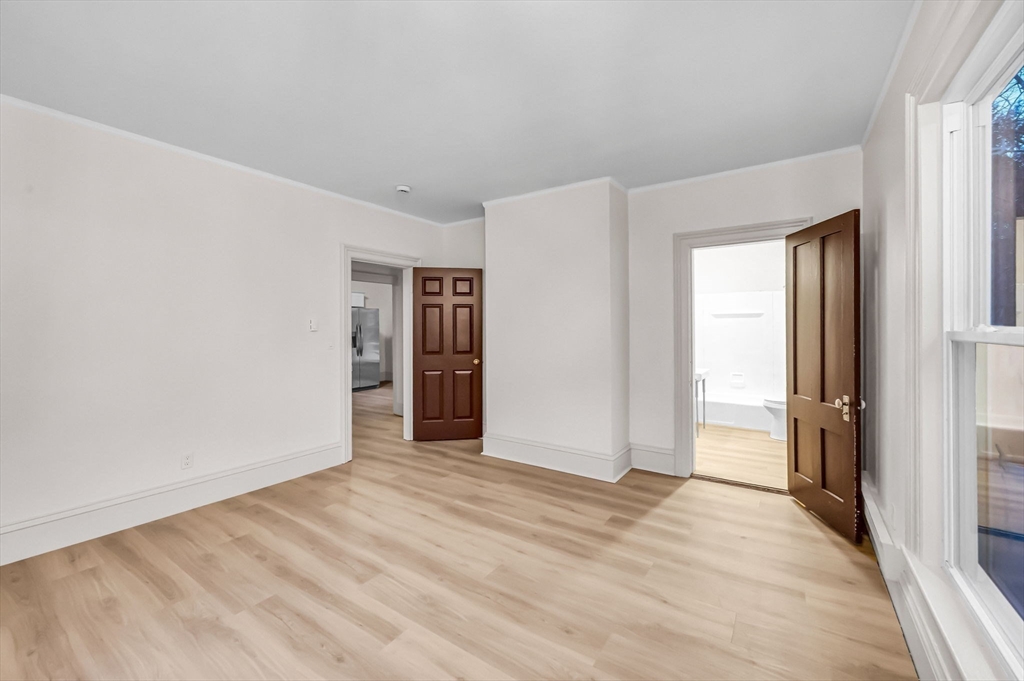 48 Gray Street Amherst, MA 01002 - Photo 23 of 42 a view of an empty room with wooden floor and window