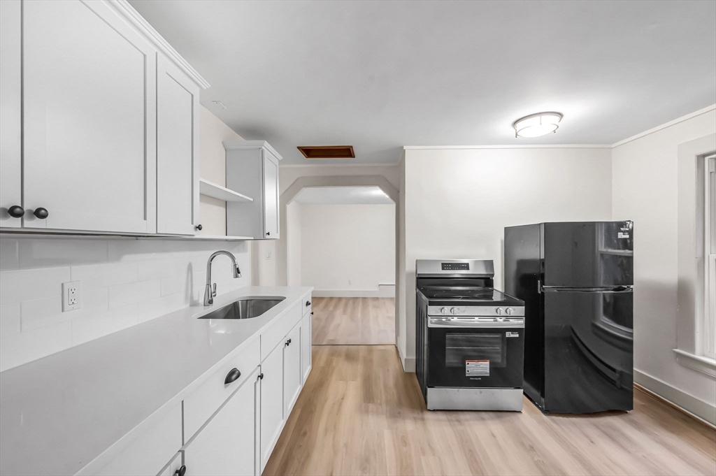 48 Gray Street Amherst, MA 01002 - Photo 26 of 42 a kitchen with a refrigerator and a sink