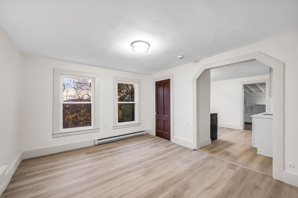48 Gray Street Amherst, MA 01002 - Photo 27 of 42 a view of an empty room with window and wooden floor