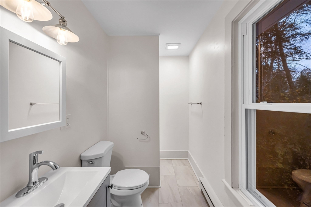 48 Gray Street Amherst, MA 01002 - Photo 29 of 42 a white toilet sitting next to a bathroom sink