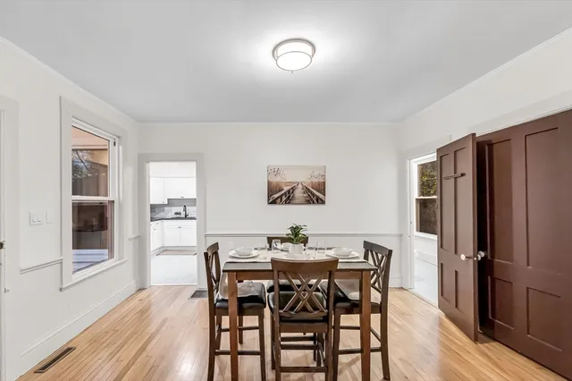 a view of a dining room with furniture window and wooden floor