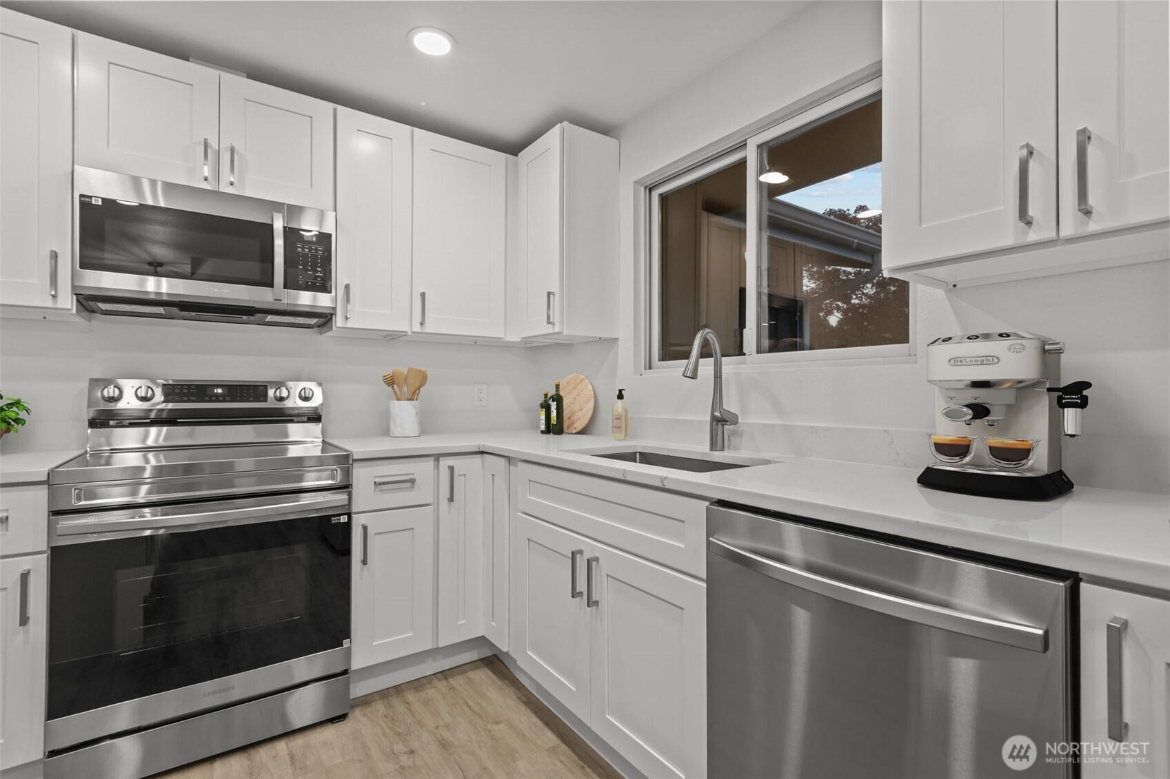 21316 188th Avenue Southeast Renton, WA 98058 - Photo 10 of 40 a kitchen with cabinets stainless steel appliances and wooden cabinets