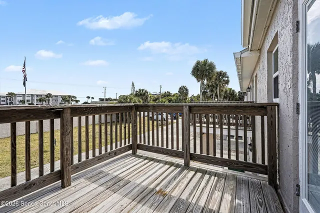 a view of wooden balcony with outdoor seating
