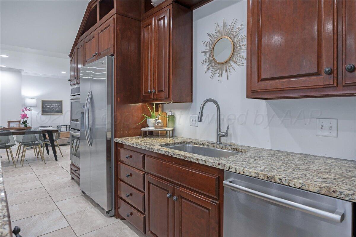 2819 South Hayden Street Amarillo, TX 79109 - Photo 15 of 56 a kitchen with stainless steel appliances granite countertop a sink and a granite counter tops