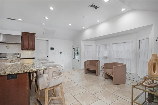 a kitchen with granite countertop a sink and cabinets