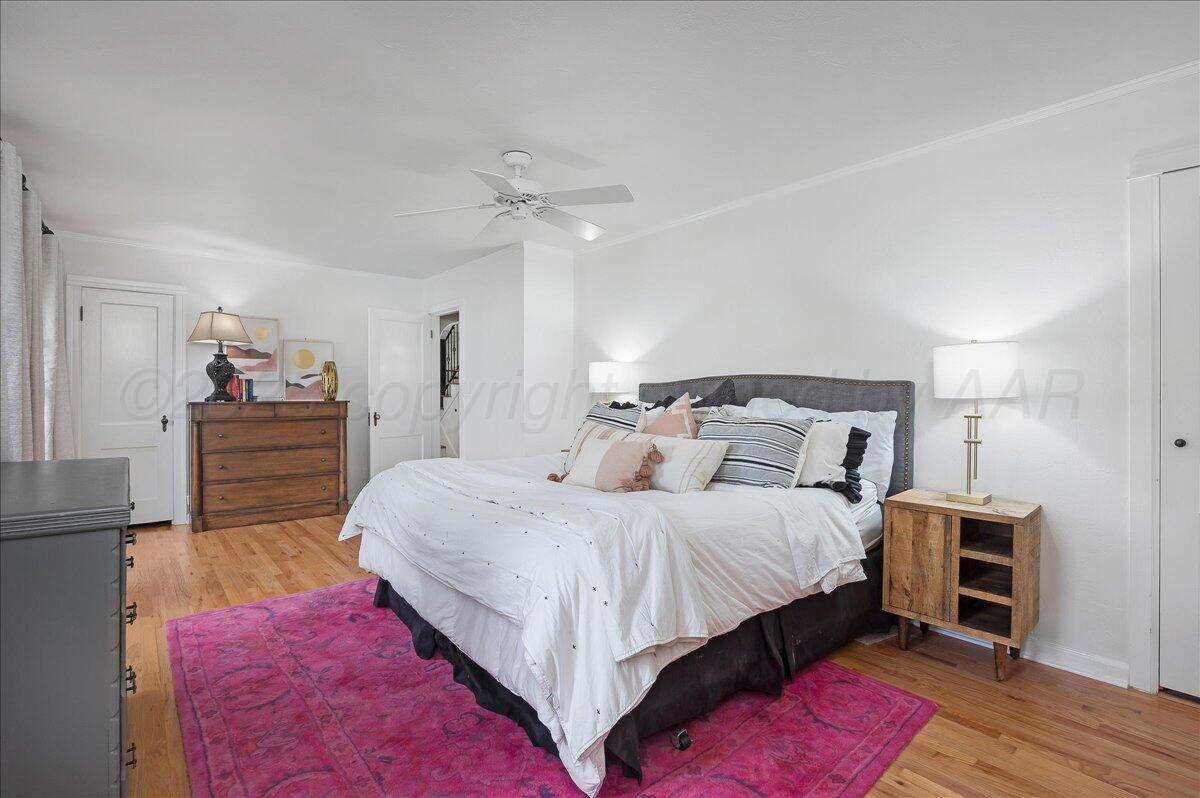 2819 South Hayden Street Amarillo, TX 79109 - Photo 21 of 56 a bedroom with a bed and a chandelier