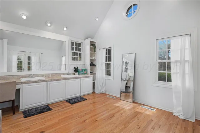 a view of a livingroom with wooden furniture and windows