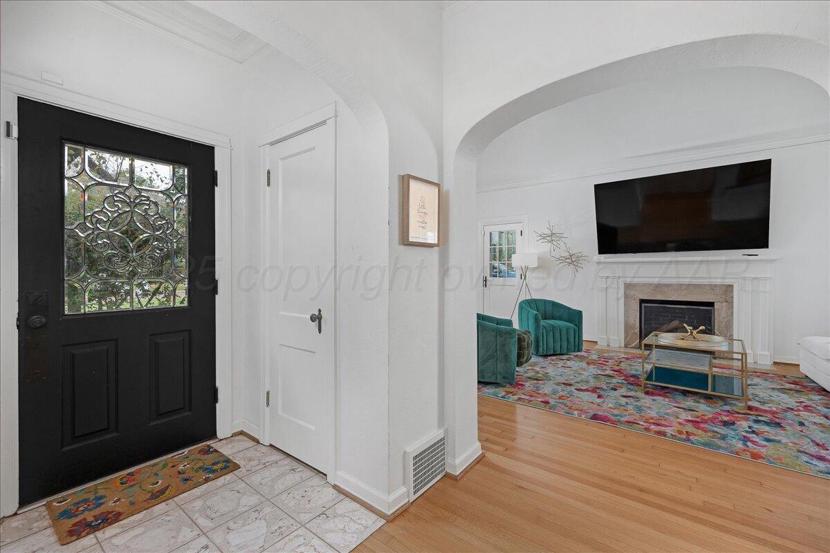 2819 South Hayden Street Amarillo, TX 79109 - Photo 3 of 56 a living room with furniture a fireplace and a flat screen tv