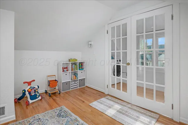 a living room with furniture a window and gym equipment