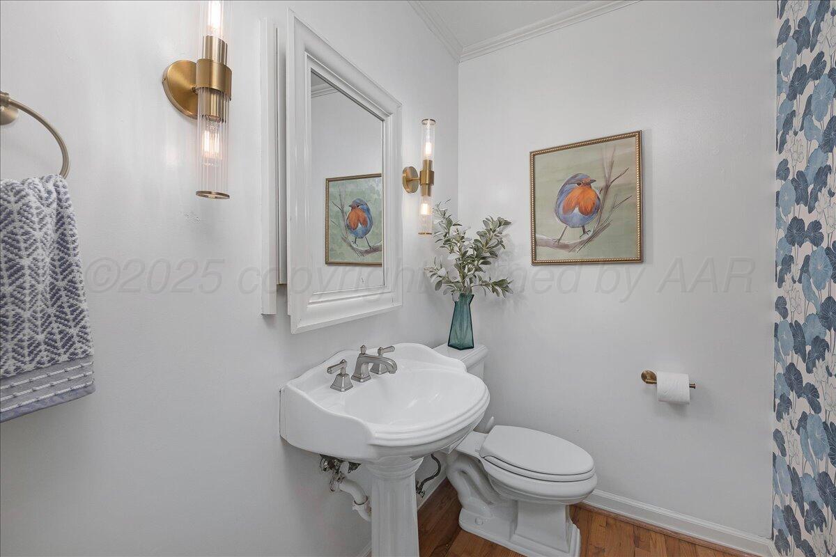 2819 South Hayden Street Amarillo, TX 79109 - Photo 43 of 56 a bathroom with a toilet sink and mirror