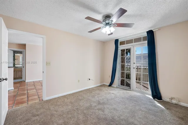 an empty room with closet and fan