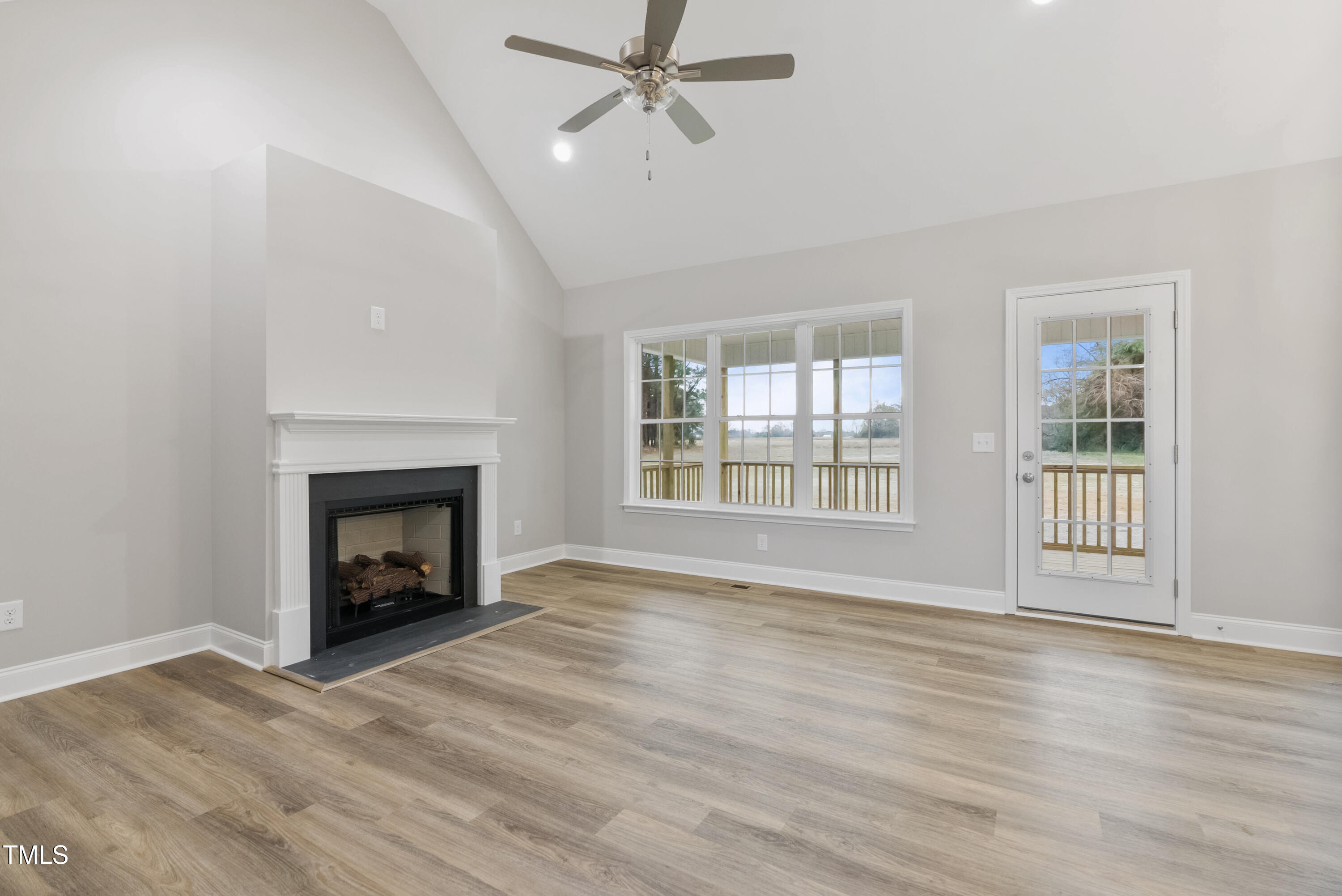 552 Rowan Road Clinton, NC 28328 - Photo 13 of 46 wooden floor fireplace and windows in an empty room