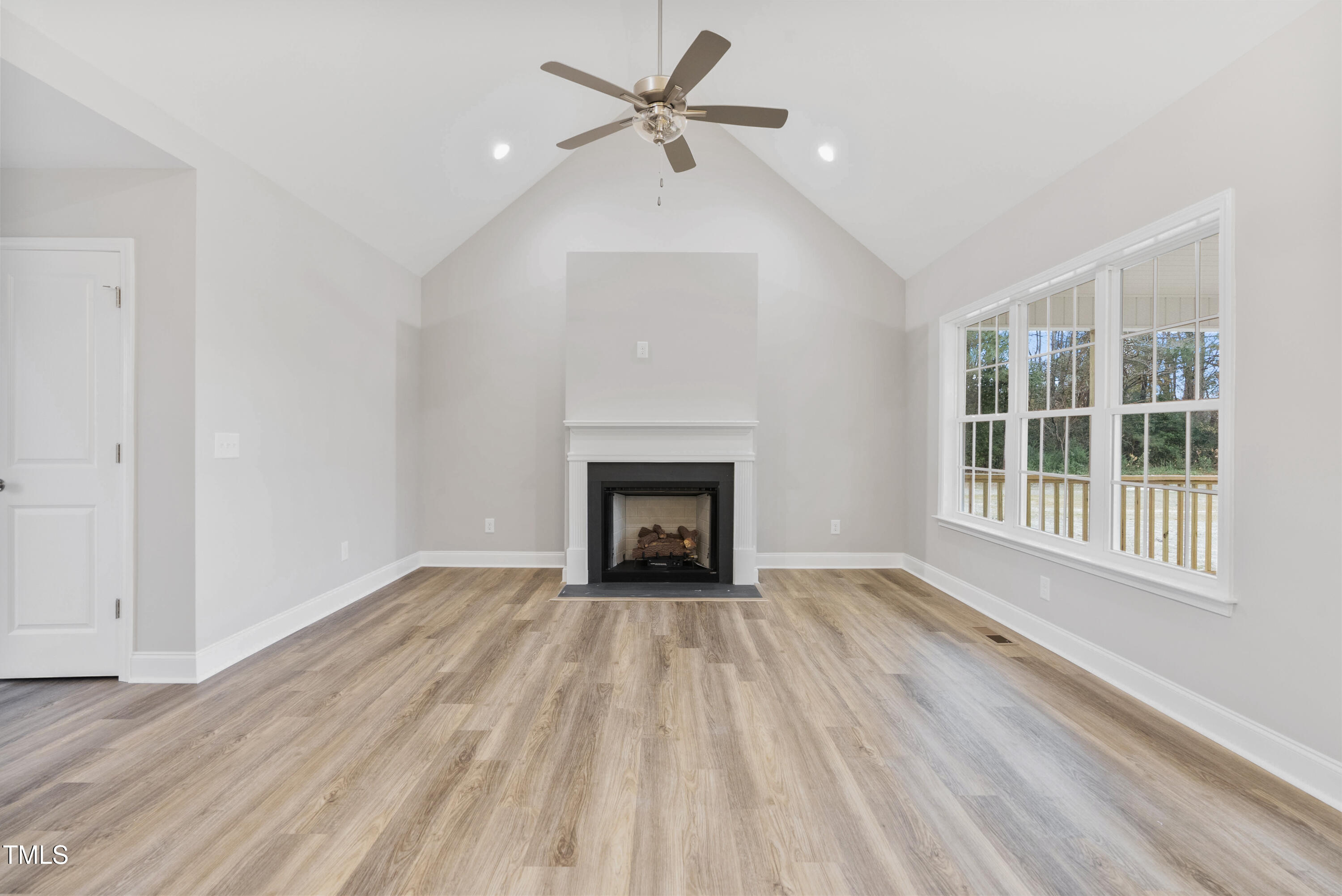 552 Rowan Road Clinton, NC 28328 - Photo 15 of 46 a view of an empty room with a window and fireplace