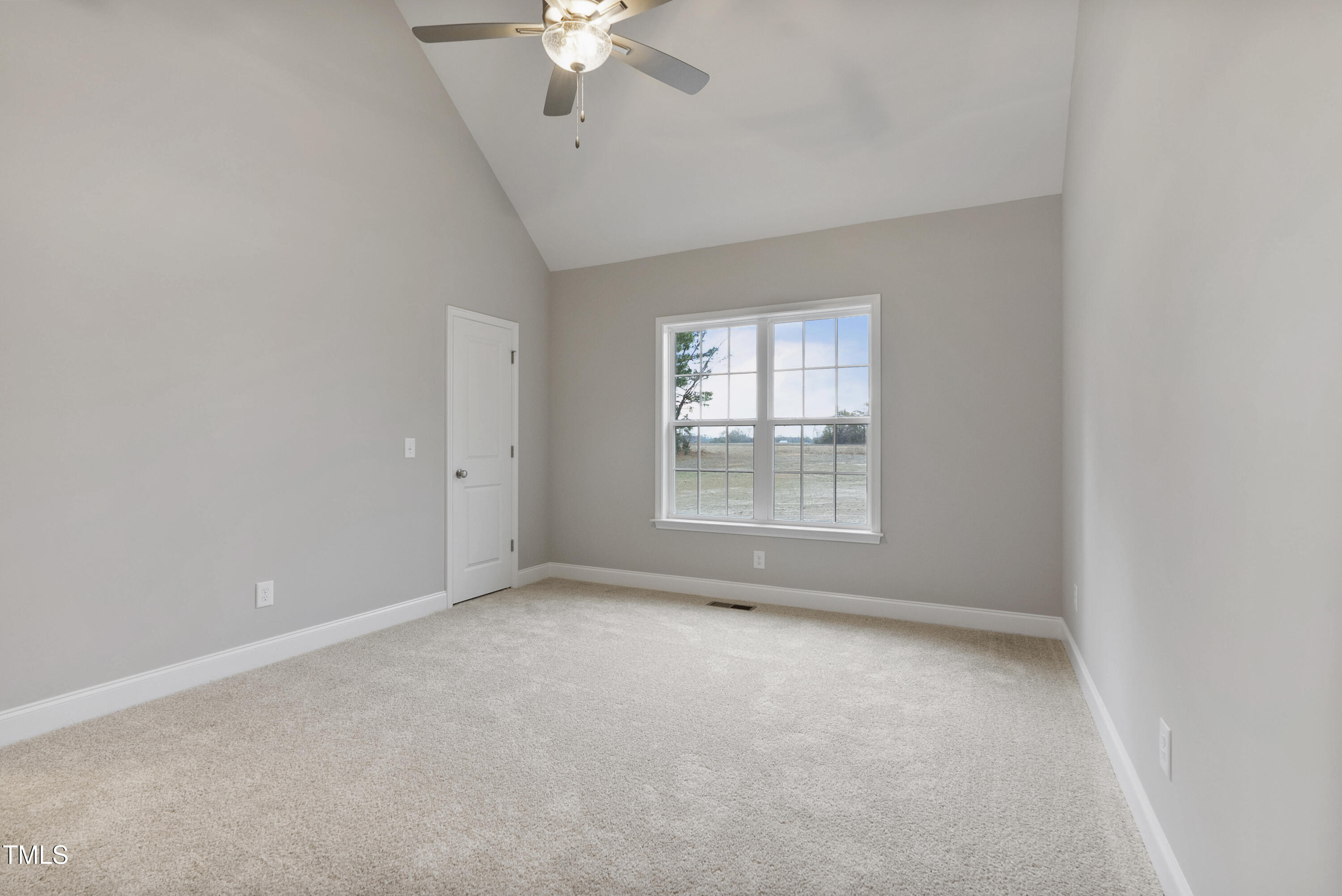 552 Rowan Road Clinton, NC 28328 - Photo 17 of 46 an empty room with a chandelier fan and windows