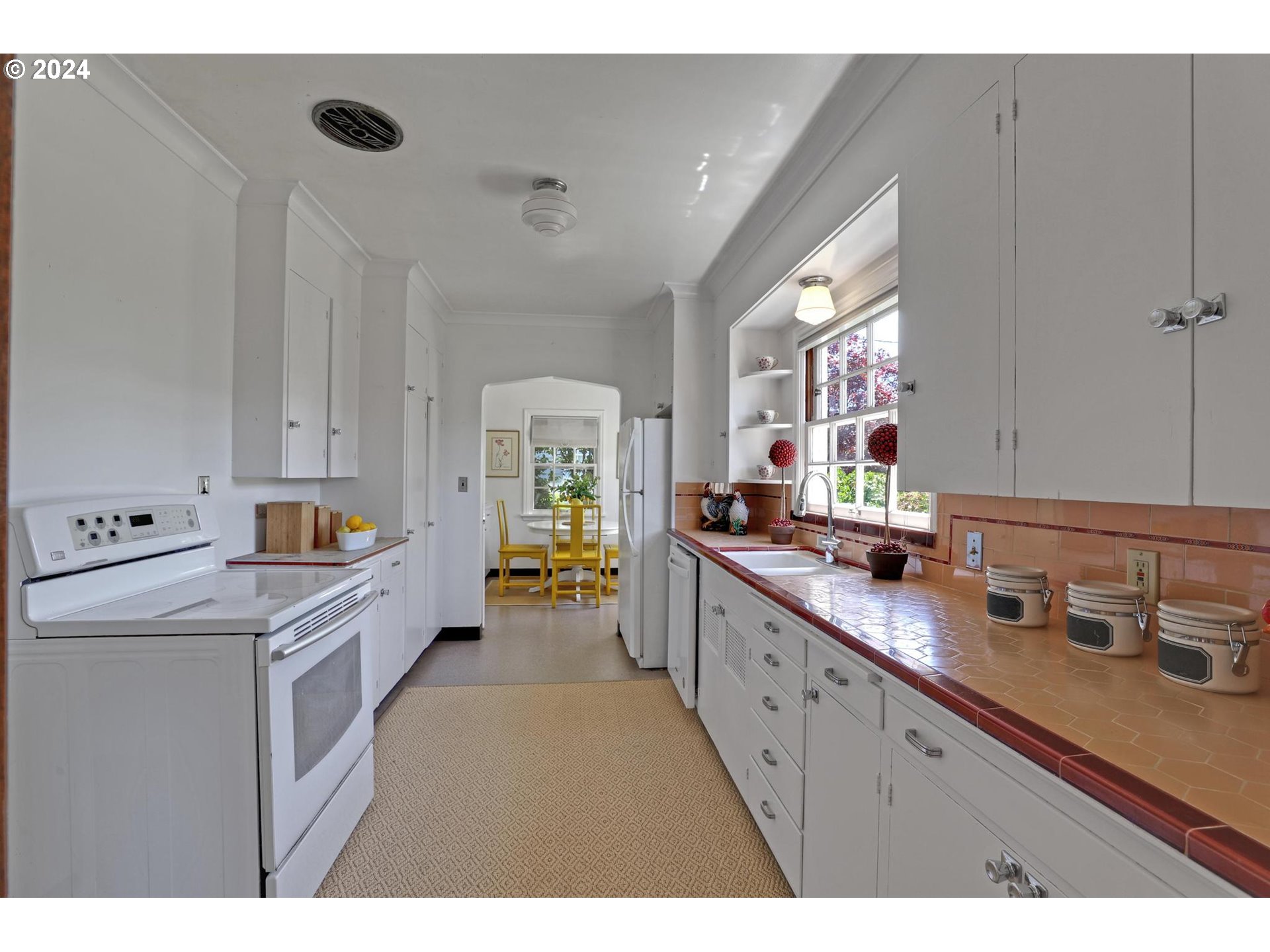 6003 Southeast Stephens Street Portland, OR 97215 - Photo 16 of 46 a kitchen with sink cabinets and window