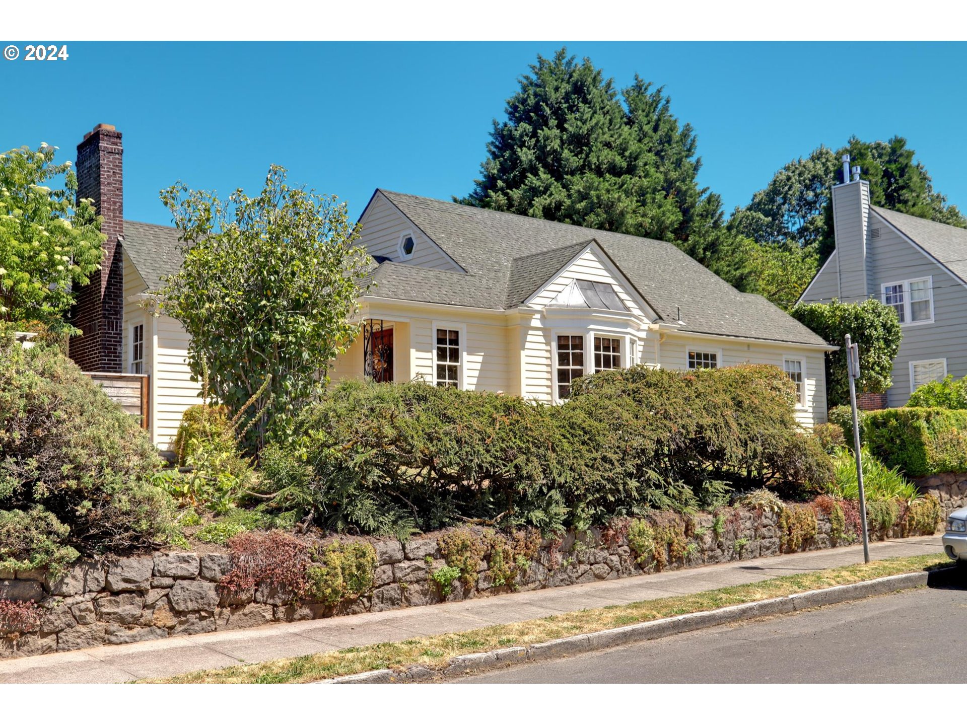 6003 Southeast Stephens Street Portland, OR 97215 - Photo 2 of 46 a front view of a house with a yard