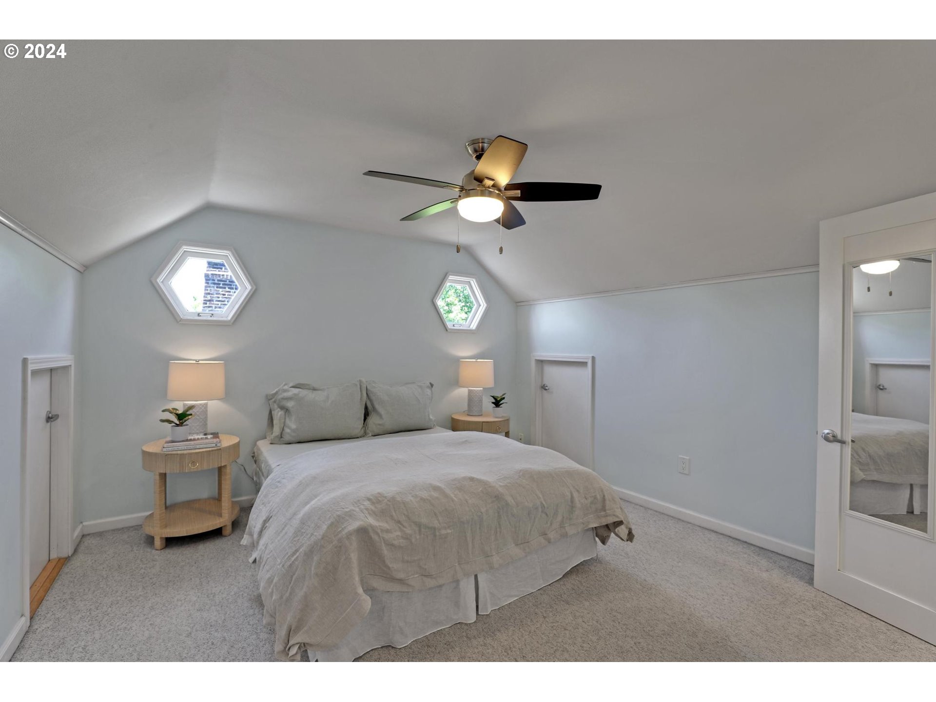 6003 Southeast Stephens Street Portland, OR 97215 - Photo 28 of 46 a bedroom with a bed and a chandelier