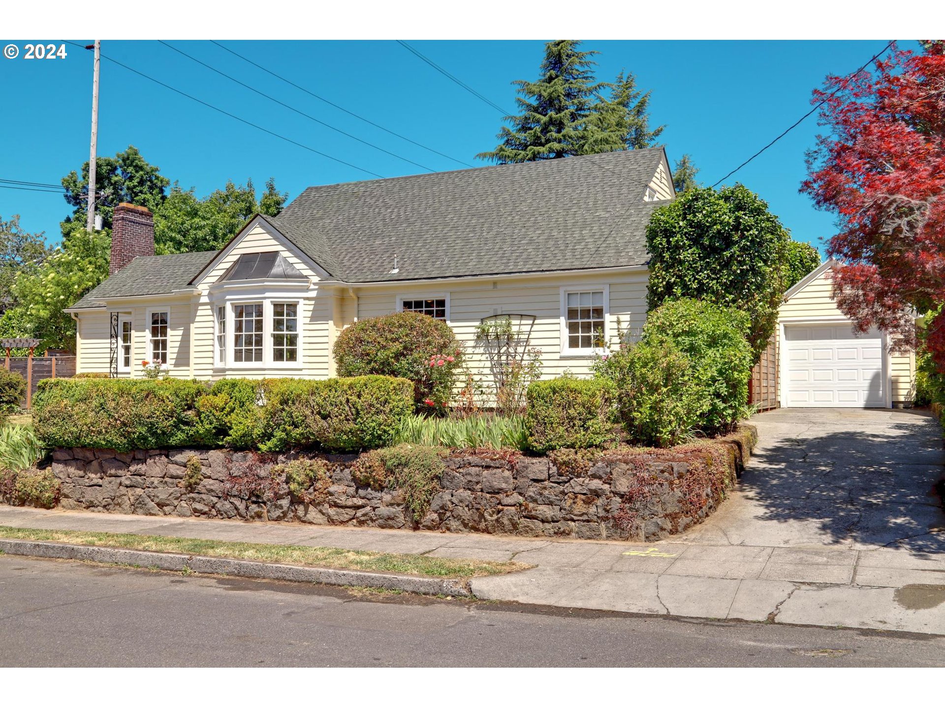 6003 Southeast Stephens Street Portland, OR 97215 - Photo 4 of 46 a front view of a house with a garden