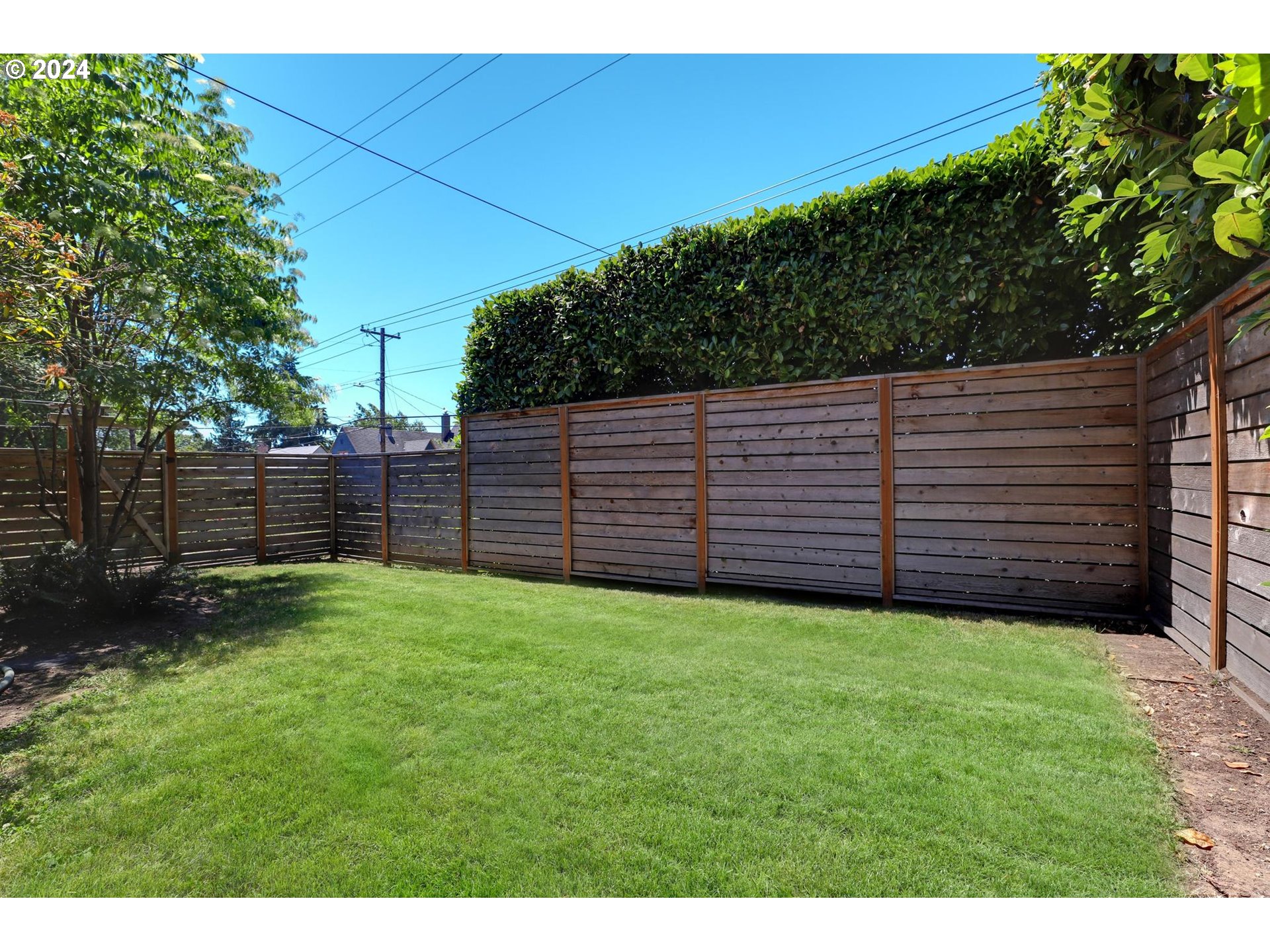 6003 Southeast Stephens Street Portland, OR 97215 - Photo 43 of 46 a view of a backyard with wooden fence