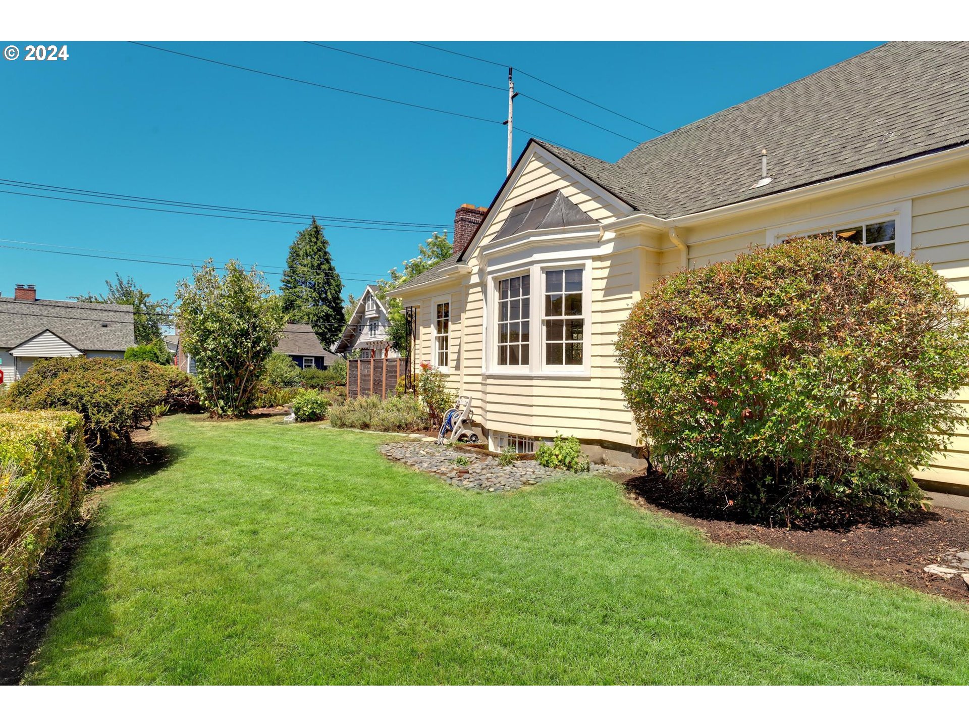 6003 Southeast Stephens Street Portland, OR 97215 - Photo 44 of 46 a front view of a house with a yard